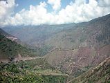 15 Verdant Steep Sided Valley From Paved Road After Kaghan We drove over a very good dirt road from Naran to Kaghan.  We followed the Kunhar River through the verdent steep sided valley. Just past Kaghan, the very good newly paved road begins, interspersed with frequent dirt patches.